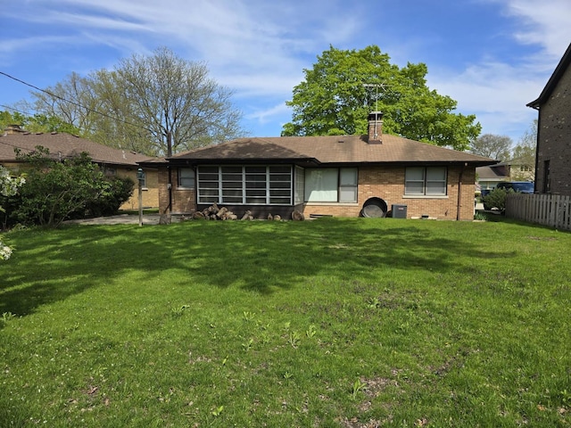 7330 N Kildare Ave, Lincolnwood, IL 60712 - rear view of house with brick siding, a chimney, and cooling unit