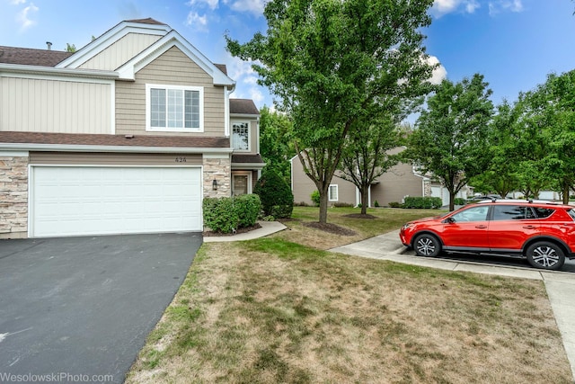 434 Locksley Dr, Streamwood, IL 60107 - view of property featuring a front lawn, stone siding, a garage, and driveway