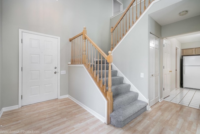 434 Locksley Dr, Streamwood, IL 60107 - entryway featuring a towering ceiling, wood finished floors, baseboards, and stairs