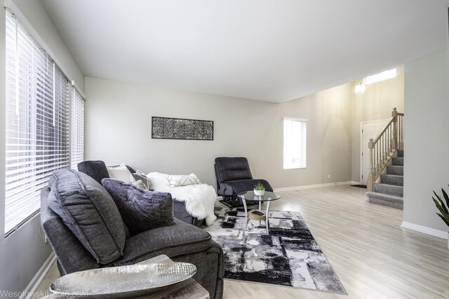 434 Locksley Dr, Streamwood, IL 60107 - living room featuring wood finished floors, baseboards, and stairs
