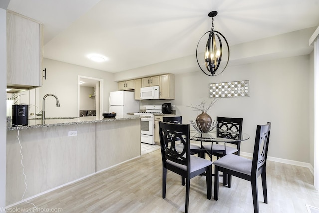 434 Locksley Dr, Streamwood, IL 60107 - dining area with light wood-style floors, a chandelier, and baseboards