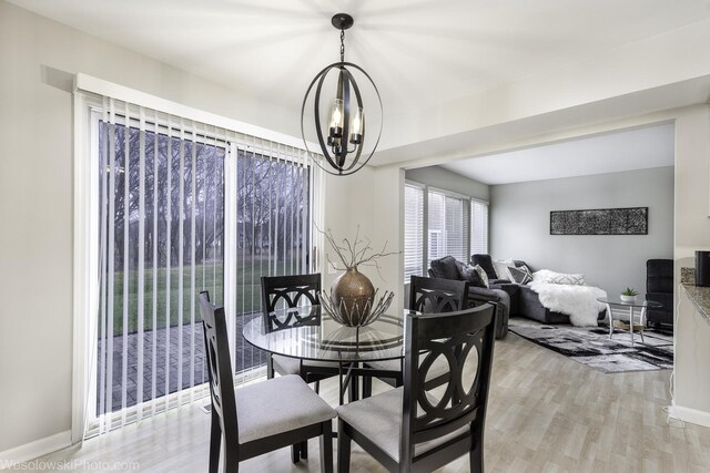 434 Locksley Dr, Streamwood, IL 60107 - dining space featuring light wood finished floors, an inviting chandelier, and baseboards