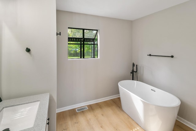 3618 Ronald Rd, Crete, IL 60417 - full bathroom featuring wood finished floors, a freestanding tub, and baseboards