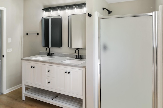 3618 Ronald Rd, Crete, IL 60417 - bathroom featuring a shower stall, double vanity, wood finished floors, and baseboards