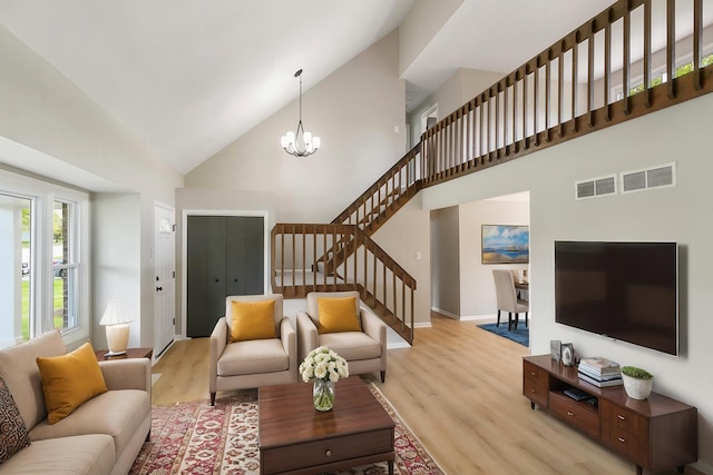3618 Ronald Rd, Crete, IL 60417 - living room featuring high vaulted ceiling, light wood-style floors, stairs, a chandelier, and baseboards