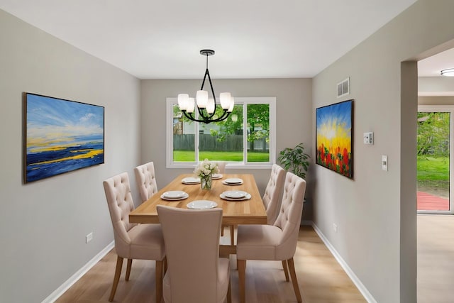3618 Ronald Rd, Crete, IL 60417 - dining area with light wood-type flooring, a chandelier, and baseboards