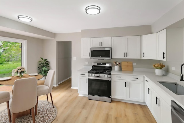 3618 Ronald Rd, Crete, IL 60417 - kitchen with stainless steel appliances, a sink, light countertops, and light wood-style floors