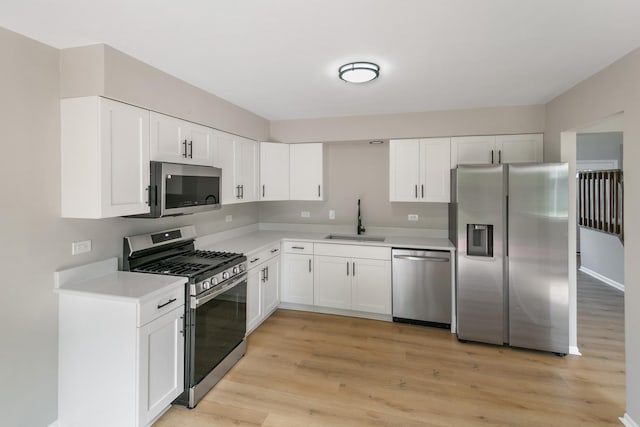 3618 Ronald Rd, Crete, IL 60417 - kitchen with stainless steel appliances, a sink, light countertops, light wood-style flooring, and white cabinets