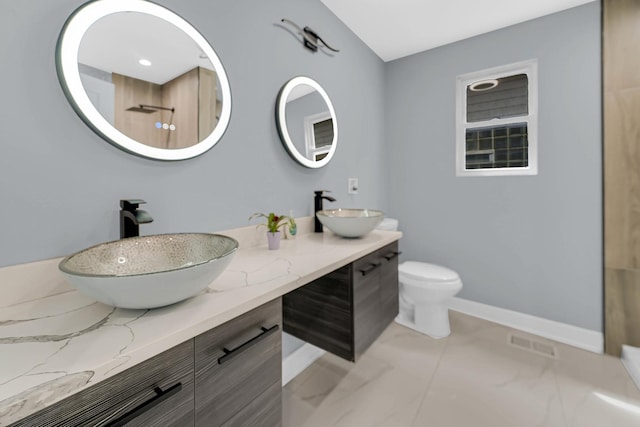 full bathroom featuring a sink, toilet, baseboards, and visible vents