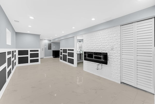 interior space featuring marble finish floor, a fireplace, and recessed lighting