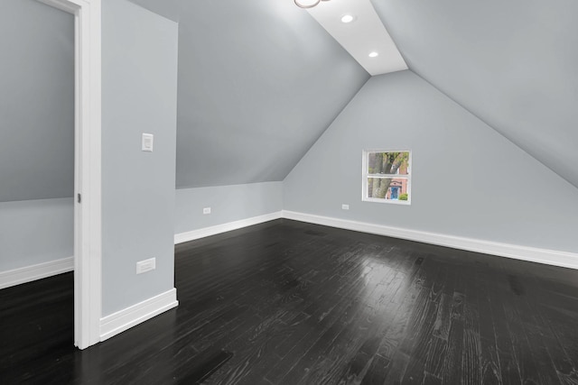bonus room with dark wood finished floors, vaulted ceiling, baseboards, and recessed lighting