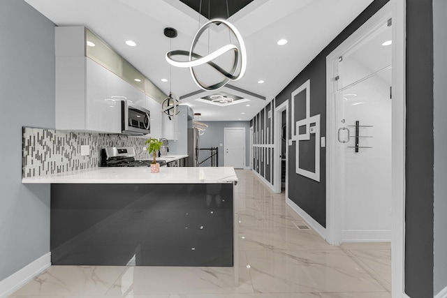 kitchen with baseboards, marble finish floor, backsplash, light countertops, and appliances with stainless steel finishes