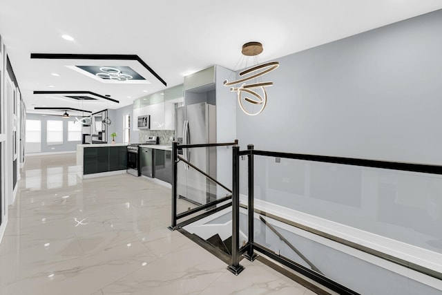 stairs featuring a chandelier, marble finish floor, and baseboards
