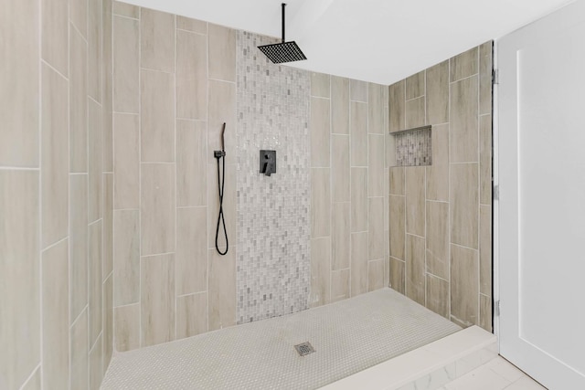 bathroom with tiled shower