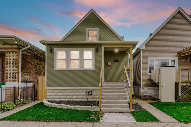 bungalow-style house with fence
