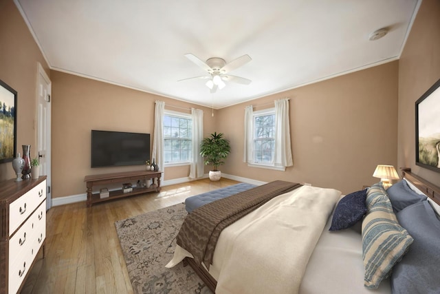8436 Kedvale Ave, Skokie, IL 60076 - bedroom featuring crown molding, hardwood / wood-style floors, baseboards, and a ceiling fan