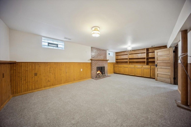 8436 Kedvale Ave, Skokie, IL 60076 - below grade area featuring a brick fireplace, wood walls, wainscoting, and light colored carpet