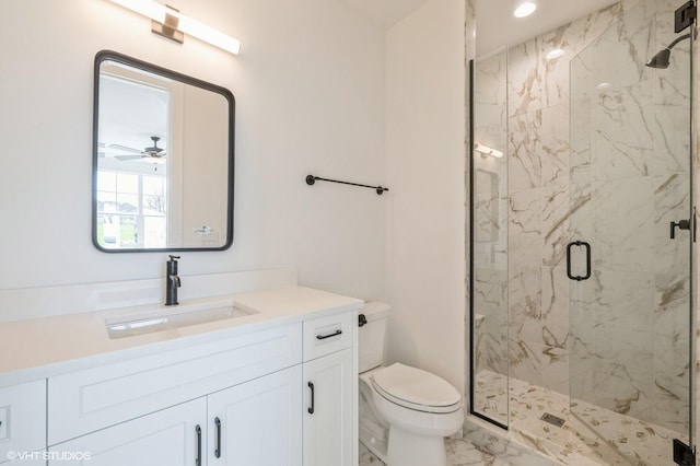 bathroom featuring a ceiling fan, toilet, marble finish floor, vanity, and a marble finish shower