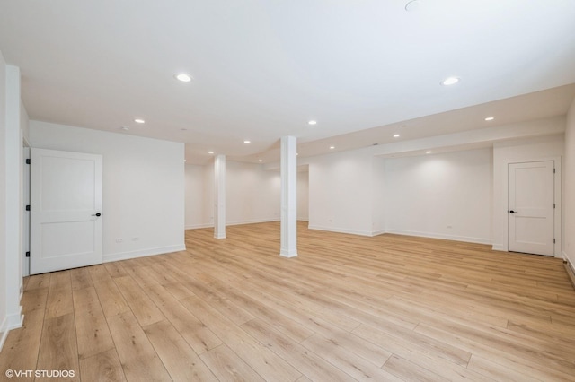 finished basement with baseboards, light wood finished floors, and recessed lighting