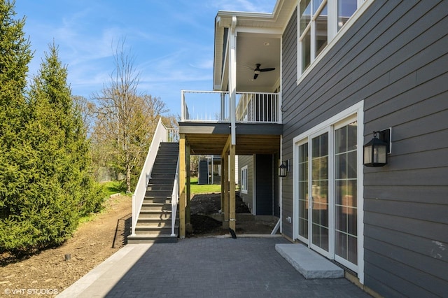 view of property exterior with stairs and a patio