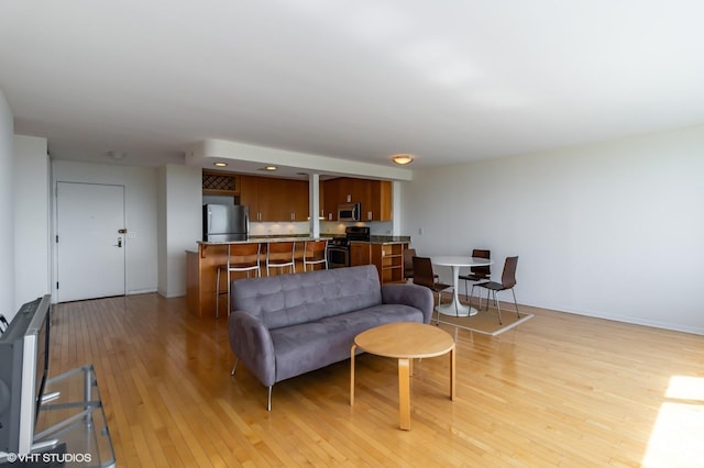 living room with light wood finished floors and baseboards