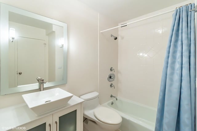bathroom with shower / tub combo, toilet, and vanity