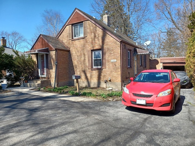 372 55th St, Clarendon Hills, IL 60514 - view of side of home with brick siding and a chimney