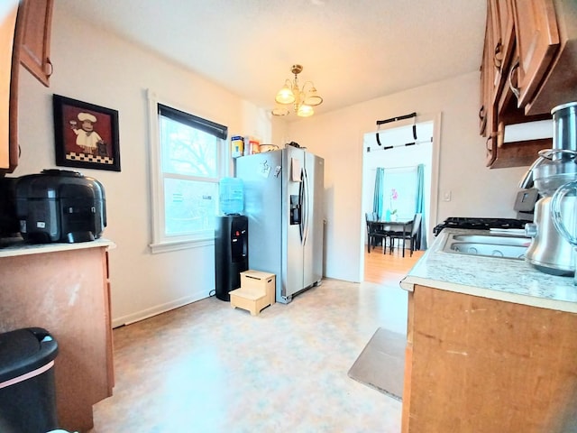 372 55th St, Clarendon Hills, IL 60514 - kitchen with stainless steel fridge and a chandelier