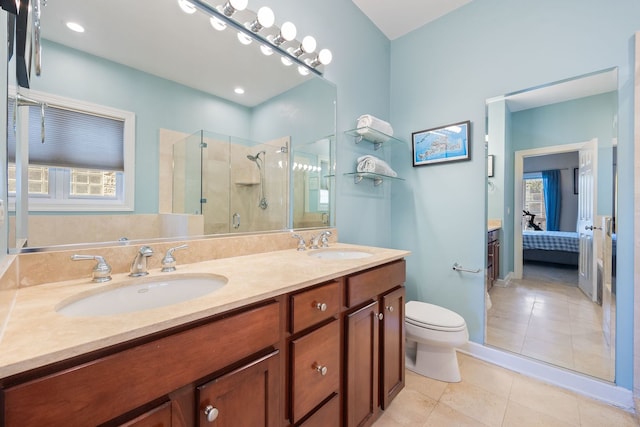 full bathroom featuring a shower stall, tile patterned floors, connected bathroom, double vanity, and toilet