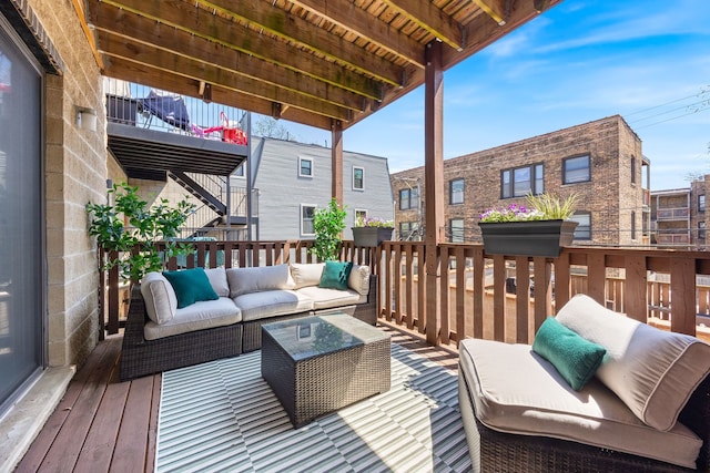 wooden terrace featuring outdoor lounge area and stairs