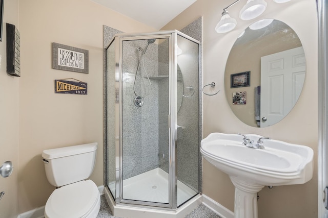 full bath with a stall shower, toilet, and baseboards