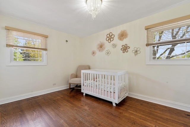 200 Marshall Dr, Des Plaines, IL 60016 - bedroom with baseboards, wood finished floors, and a crib