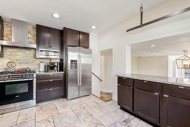 200 Marshall Dr, Des Plaines, IL 60016 - kitchen featuring appliances with stainless steel finishes, wall chimney exhaust hood, backsplash, dark brown cabinetry, and light stone countertops