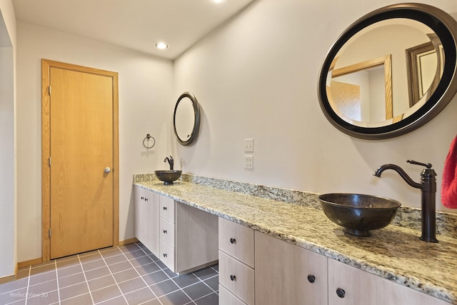 full bathroom featuring tile patterned flooring, double vanity, and recessed lighting