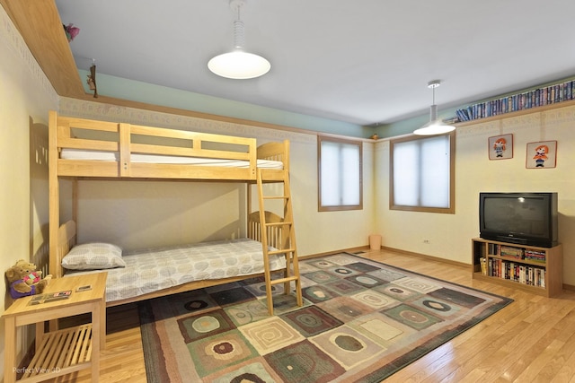 bedroom with wood finished floors and baseboards