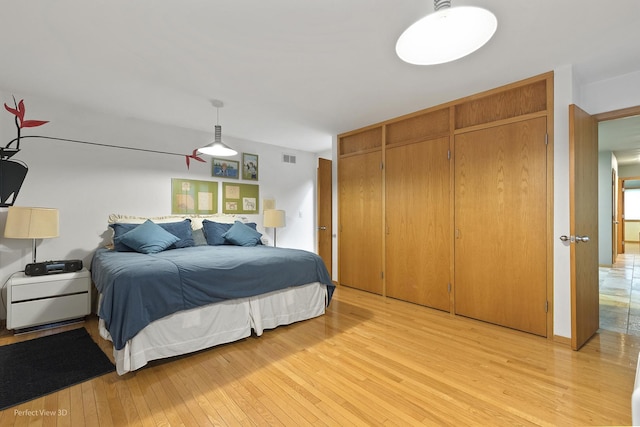 bedroom featuring light wood-style floors and a closet