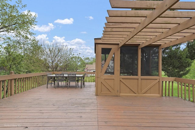 wooden terrace featuring a pergola, outdoor dining space, and a sunroom