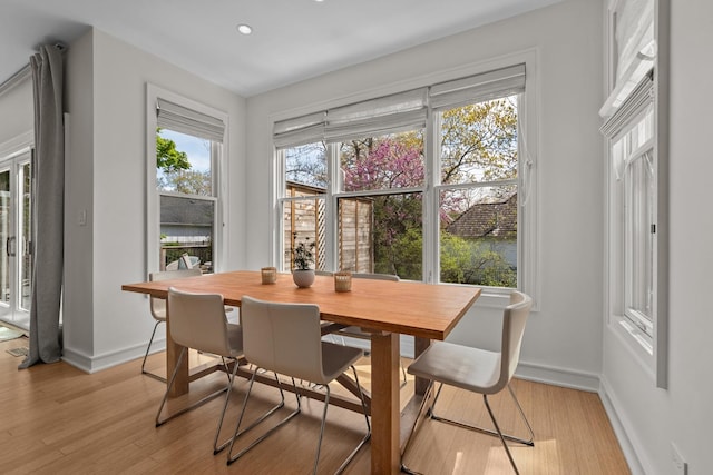 dining area featuring light wood-type flooring, baseboards, and recessed lighting