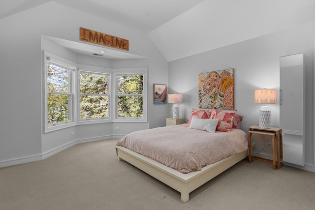 carpeted bedroom with vaulted ceiling and baseboards