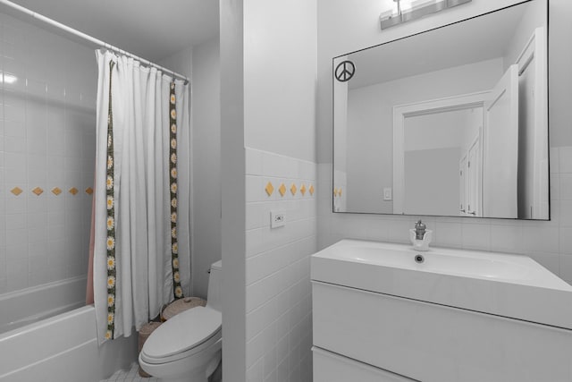 bathroom with toilet, tile walls, vanity, and shower / bath combo with shower curtain