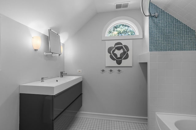 full bath with lofted ceiling, tile patterned flooring, shower / washtub combination, and double vanity