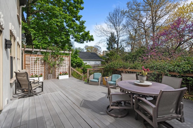 wooden terrace featuring outdoor dining space