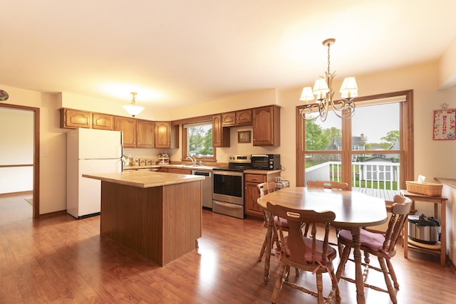1494 Applegate Dr, Naperville, IL 60565 - kitchen with stainless steel appliances, a kitchen island, light countertops, a chandelier, and decorative light fixtures