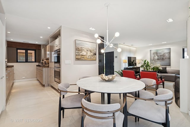 dining room featuring recessed lighting, a chandelier, and baseboards