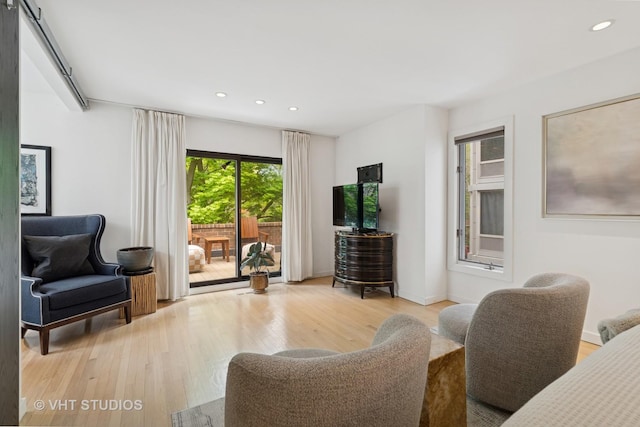 living area with light wood finished floors, recessed lighting, and baseboards