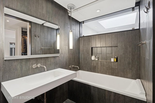 full bathroom with a bath, a skylight, and a shower