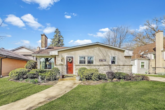view of front of house with a front yard, central AC, stone siding, and a chimney