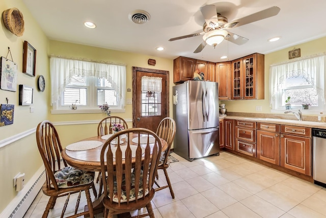kitchen with stainless steel appliances, a baseboard radiator, light countertops, glass insert cabinets, and recessed lighting