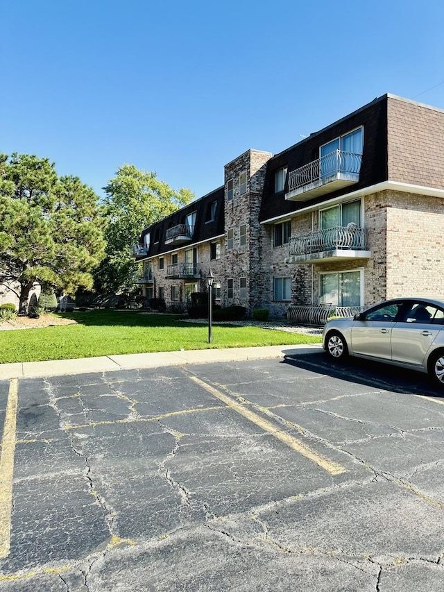 view of building exterior featuring uncovered parking