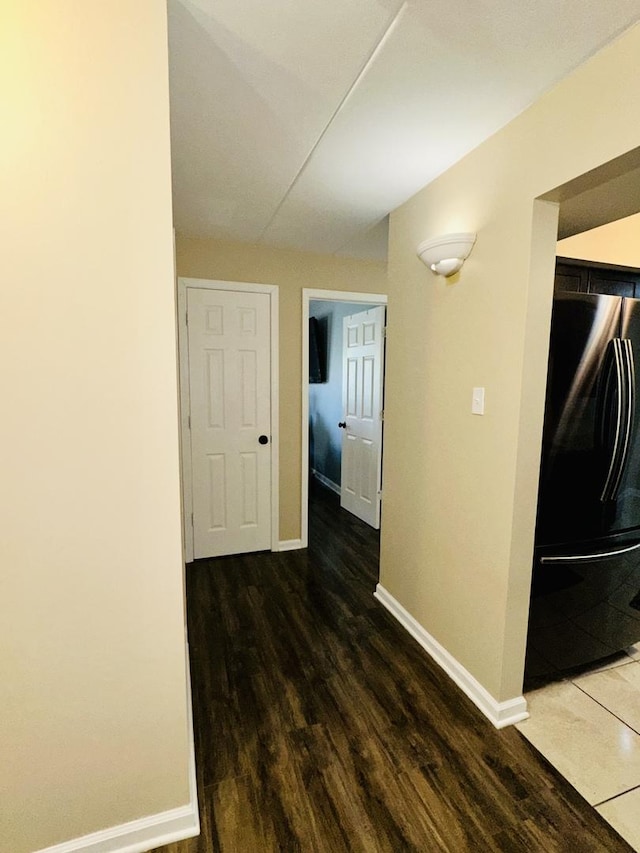 hallway with baseboards and wood finished floors